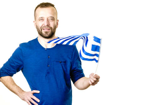 Happy joful man holding greek flag. Tourism, country presentation and promotion concept.の写真素材
