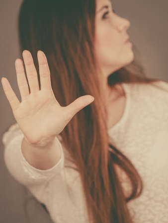 Angry apodicticity woman showing stop sign gesture with open hand, denying something,