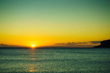Scenic sunset or sunrise over sea surface. Natural scenery, beautiful landscapeの写真素材
