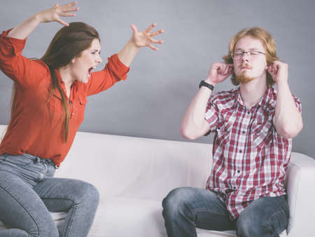 Man and woman having conflict. Female ignoring what her boyfriend is saying. Friendship, couple breakup difficulties and problems concept.の写真素材