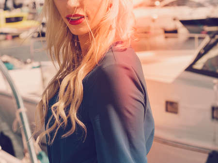 Beautiful dreamy adult fashionable woman wearing blue navy shirt and red lipstick.の写真素材