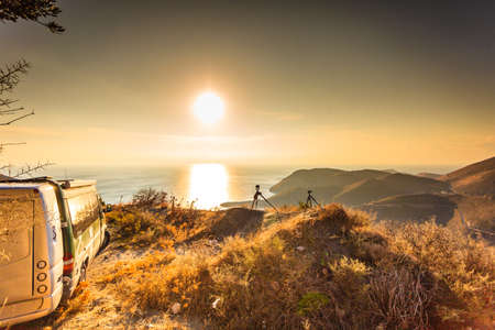 Tourism vacation and travel. Camper van on nature at sunrise over sea surface, Greece Peloponnese Mani Peninsula.のeditorial素材