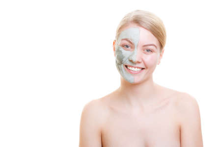 Skin care, cosmetology concept. Woman having mud algae mask on her face, smiling and enjoying herselfの写真素材