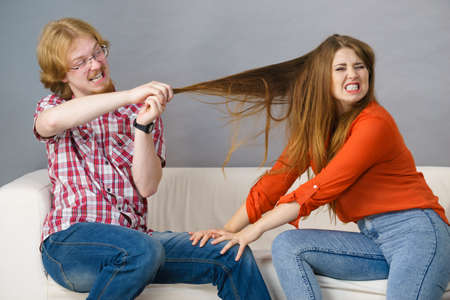 Teen brother and sister having horrible fight, man pulling woman hair. Friendship and family...