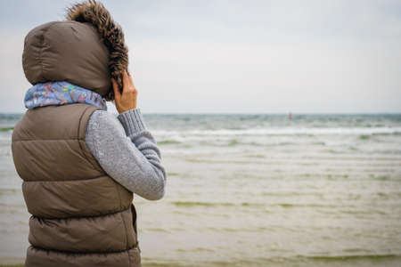 Relaxation and leisure. Woman walking on beach. Female tourist relax near to water place on nature....