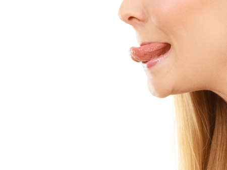 Fooling around, making silly faces concept. Blonde woman having tongue in clothespin