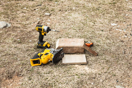 Drilling in piece of wood. Diy tools objects, driller and ... Renovation, building, fixing wooden...