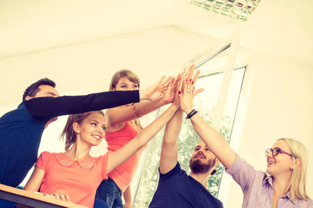 Education, friendship, success and teenage concept. Team of friends college students showing unity...
