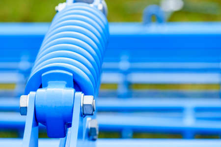 Industrial details, mechanical objects and tools concept. Spring on steel big machinery closeupの写真素材
