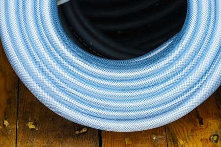 Machines, production concept. Detailed closeup of blue flexible plastic hose, pipes.