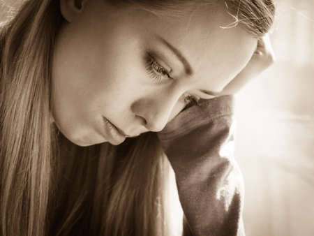 People and solitude concept. Alone sad troubled young woman long hair teen girl lost in thoughtの写真素材