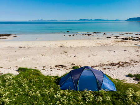 Blue tent on Gimsoysand sandy beach in summer. Camping on ocean shore. Lofoten archipelago Norway. Holidays and travel.の写真素材