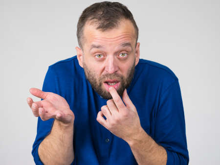 Confused adult man seeking for solution having dumb face expression. Thinking about something,...