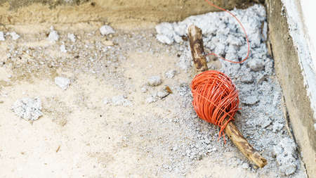 String net on wooden stick. Tool to help you set straight distances, spirit level.