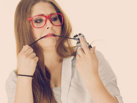 Young woman trying to figure out video console joystick pad. Female understanding gaming