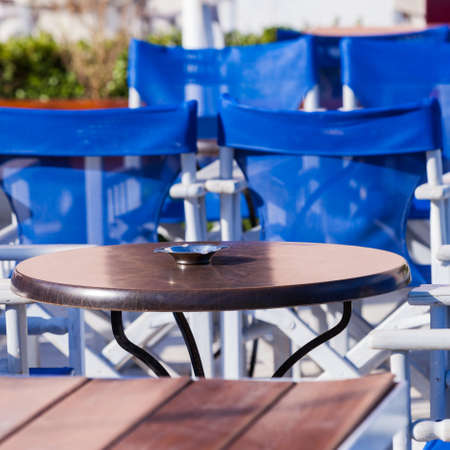 Blue white table and chairs open cafe outdoor restaurant in Greece. Summer vacation on resort.の写真素材