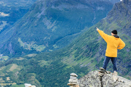 Tourism vacation and travel. Male tourist enjoying mountains landscape from Dalsnibba viewpoint,...