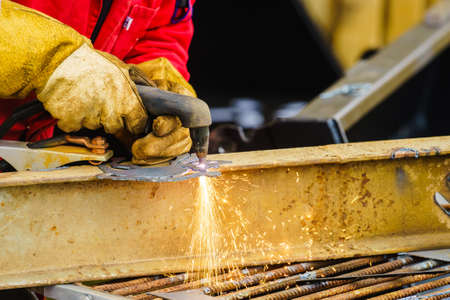 Man making art using metal cutter. Close up of industrial objects and tools concept.