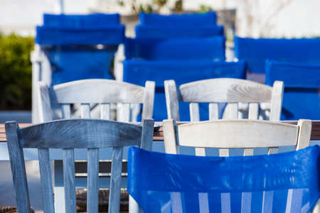 Blue white table and chairs open cafe outdoor restaurant in Greece. Summer vacation on resort.の写真素材