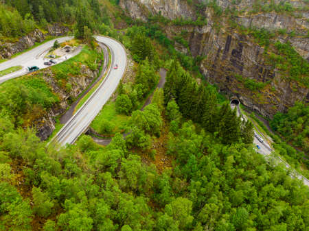 Aerial view. Old and new road with tunnel in green summer mountains, Mabodalen valley Norway. National tourist Hardangervidda route.の写真素材