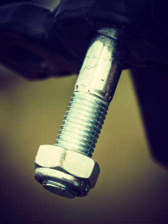 Construction machines concept. Detailed closeup of screw and bolts on indrustrial machineryの写真素材