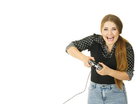 Young adult woman playing on the video console holding game pad. Gaming gamers concept.の写真素材