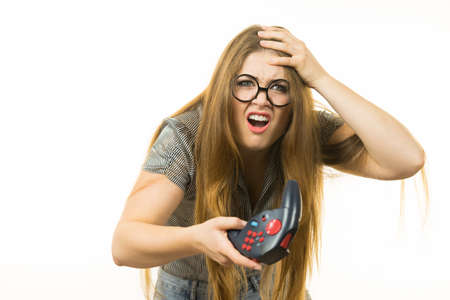 Young adult woman playing on the video console holding pad being very dissatisfied after loosing....
