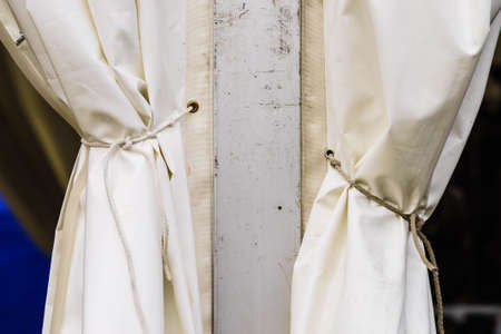 Close up of white party event tent details, hooks, stripes, cord strings. Detailed objects concept.