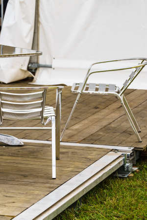 Steel metal made garden chairs and table in white party event tent.の写真素材