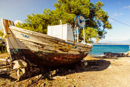 Old wooden boat on beach sea shoreの写真素材