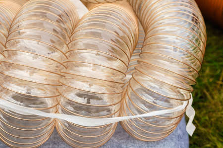 Machines, production concept. Detailed closeup of flexible plastic hose, pipes.の写真素材