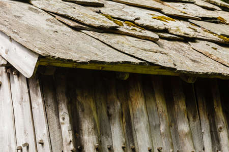 Architecture details concept. Detailed closeup of dark grey stone rock roof tiles.