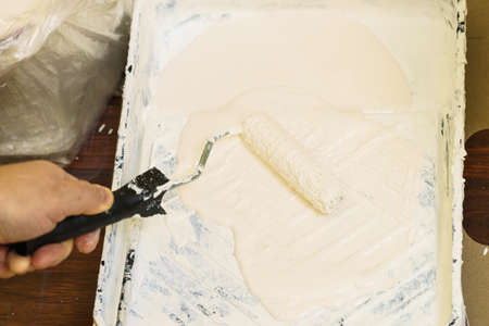 Home renovation, walls color change, diy concept. White paint with essentials equipment.