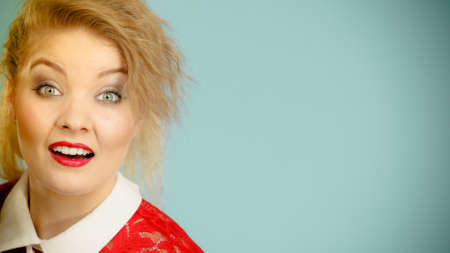 Happy joyful blonde woman with tied hair in pony tail. Female having beautiful make up.の写真素材