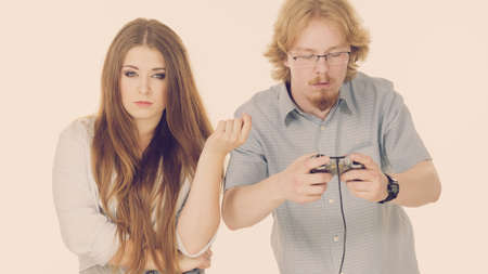 Woman is mad at her boyfriend because he play video games being addicted to gaming.