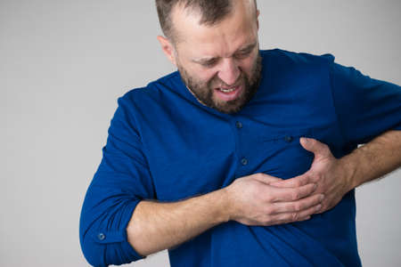 Adult man having problem with health, having heart pain in chest. Mature guy with cardiology...