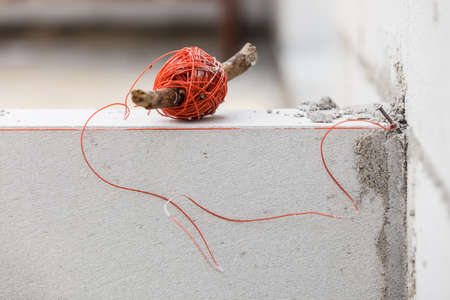 String net on wooden stick. Tool to help you set straight distances, spirit level.の写真素材