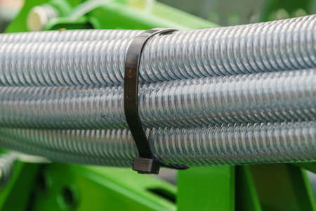 Machines, production concept. Detailed closeup of flexible plastic hose, pipes.