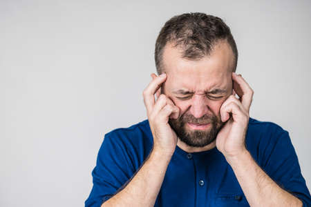 Adult man being worried about something. Guy gesturing with hands seeing unpleasand bad effects.