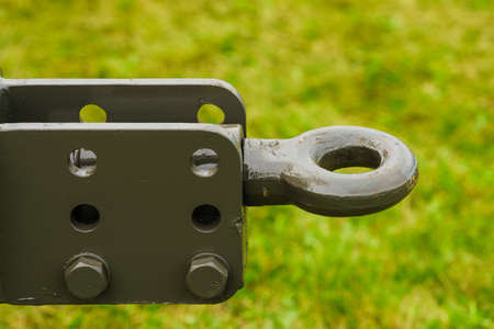 Close up on dark towbar in agricultural machine vehicle. Green grass in backround.の写真素材