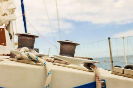 Yacht capstan with rope on sailing boat during cruise, marine objects concept.の写真素材