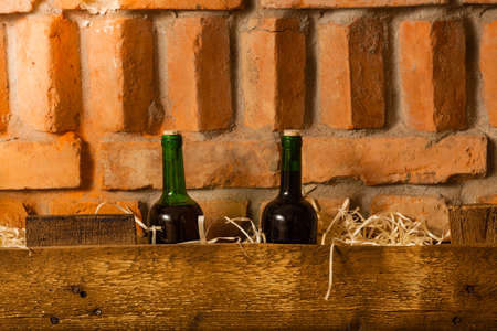 wine bottles on the wooden shelf in cellarの写真素材