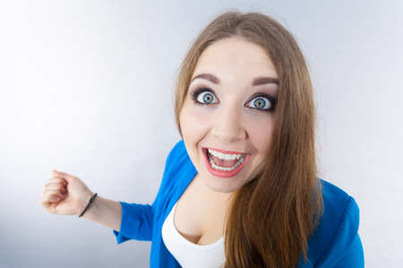 Close up on funny woman expression. Female lady being surprised shocked having wide opened eyes.