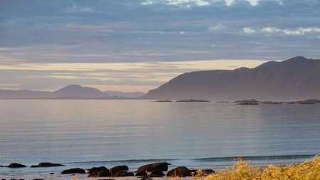 Coast of Gimsoya island, Gimsoysand sandy beach and mountains on horizon. Nordland county, Lofoten...