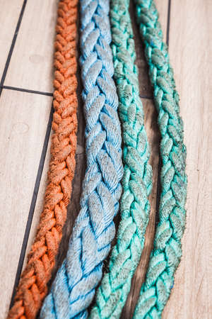 Old fashioned harbor marina sail boat ropes. Yachting details and objects concept.の写真素材