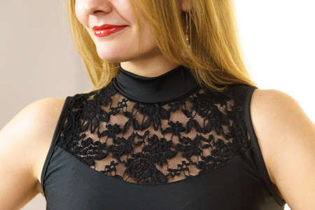 Unrecognizable woman wearing black top with laced detail on chest. Fashion, clothing style concept.の写真素材