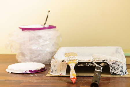 Home renovation, walls color change, diy concept. White paint with essentials equipment.