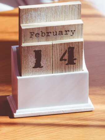 Detailed close up of wooden old fashioned calendar with 14 february valentines day date.の写真素材