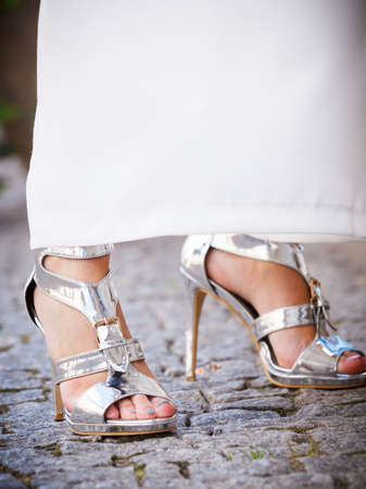 Elegant unrecognizable woman presenting fashionable urban outfit. High heels and trousers culottes.の写真素材