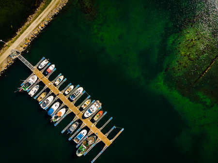 Aerial top down view. Marina dock basin with moorings and supplies for yachts and small fishing boats.の写真素材